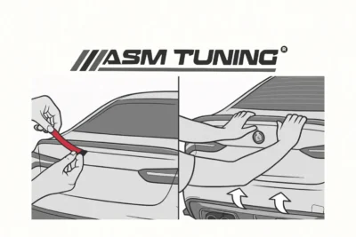 Hands peeling red adhesive backing and firmly pressing down a spoiler on a BMW trunk to secure it in place during final installation
