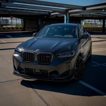 BMW X4M LCI with full carbon fibre body kit front view, featuring carbon splitter, vents and gloss aero design