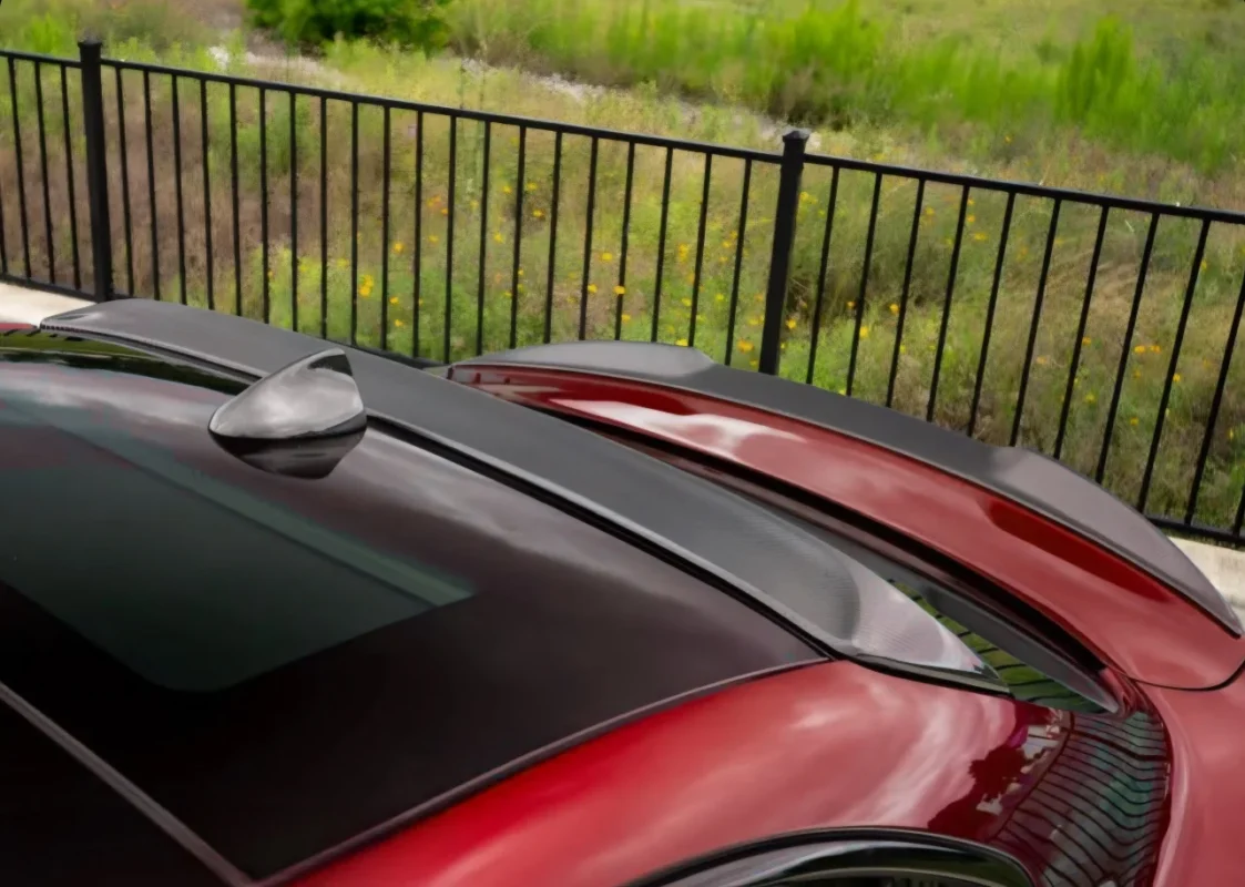 Installed view of Alfa Romeo Giulia 2016+ carbon fibre roof spoiler showing rear window lip extension for improved rear-end aerodynamics