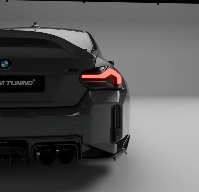 Close-up of quad exhaust tips integrated into carbon diffuser