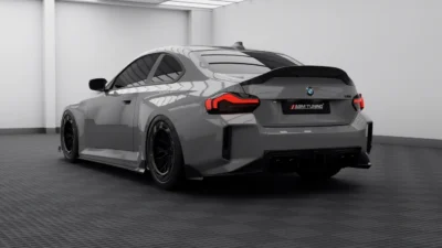 BMW G87 M2 in lightroom with rear diffuser, angled view