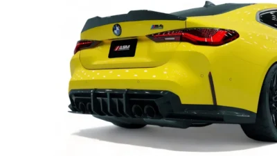 Carbon fibre rear diffuser and quad exhaust setup on yellow BMW G82 M4