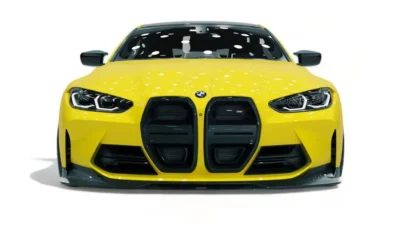 Front view of yellow BMW G82 M4 with full carbon kit