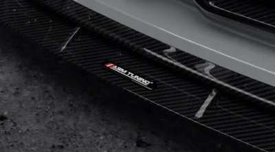 ASM Tuning badge detail on dry carbon front splitter for BMW M4 G82/G83