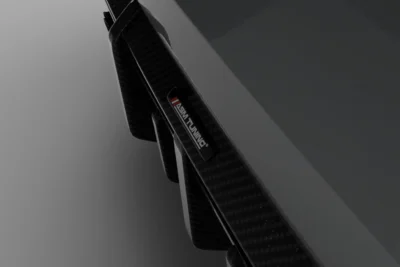 Detailed shot of ASM Tuning logo embedded on carbon fibre fin of BMW M4 G82/G83 diffuser