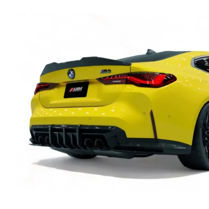 Rear close-up of yellow BMW M4 G82 highlighting carbon fibre diffuser and exhaust fitment