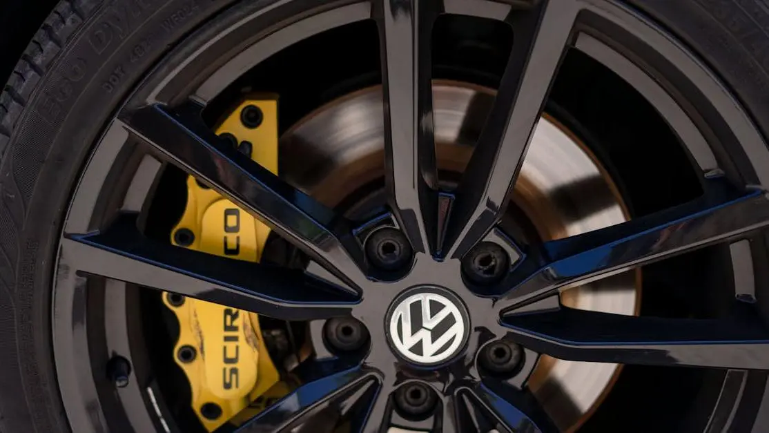 Black alloy rim and yellow brake caliper showing wheel spacers handling improvement on Volkswagen tire