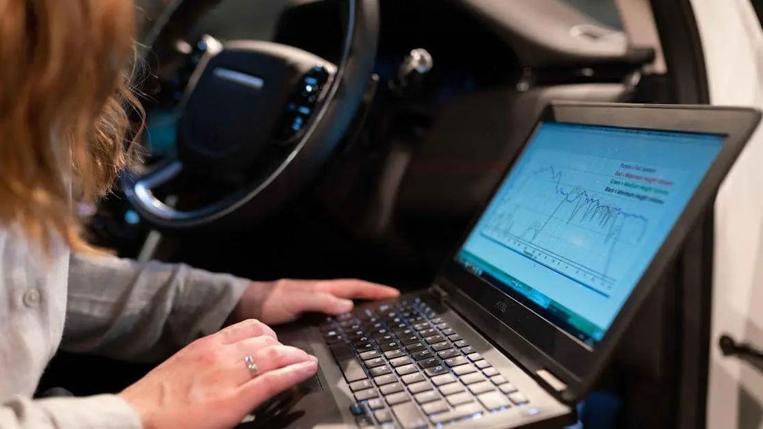 Best laptop for ECU tuning used by female engineer analyzing vehicle data inside a car