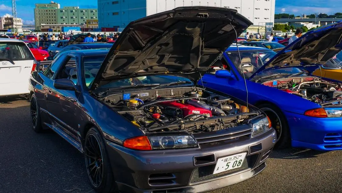 JDM cars at meet with open hoods, illustrating does ECU tuning void warranty concerns