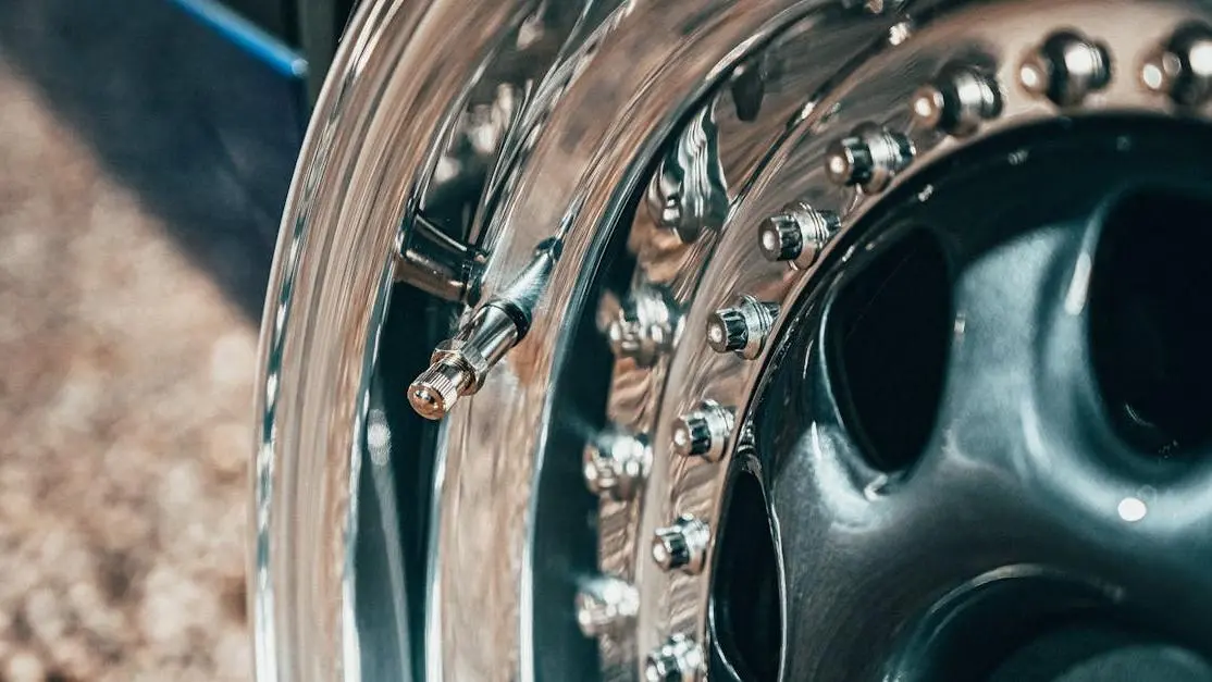 Shiny aftermarket car wheel rim with modern design, highlighting aftermarket car parts style