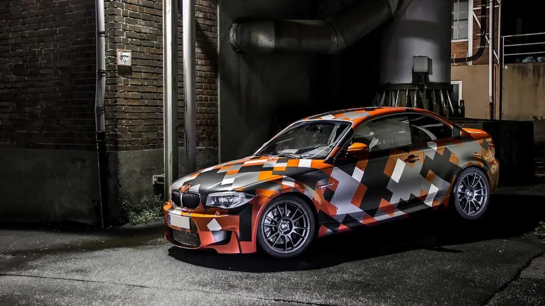 Camo-wrapped car parked at night, highlighting sleek design and vibrant colors for aftermarket vehicle parts