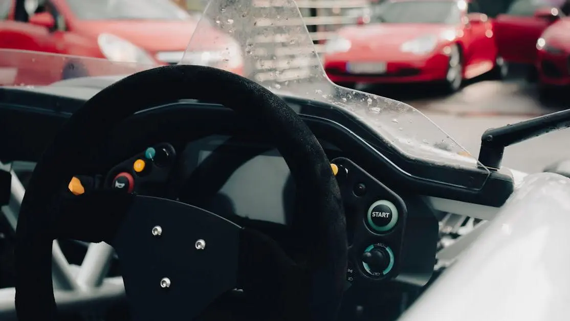 Formula 1 race car steering wheel with control buttons in the cockpit close-up