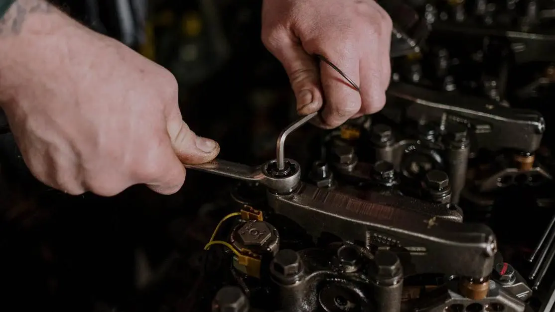 Mechanic adjusting engine components to demonstrate ignition timing tuning basics